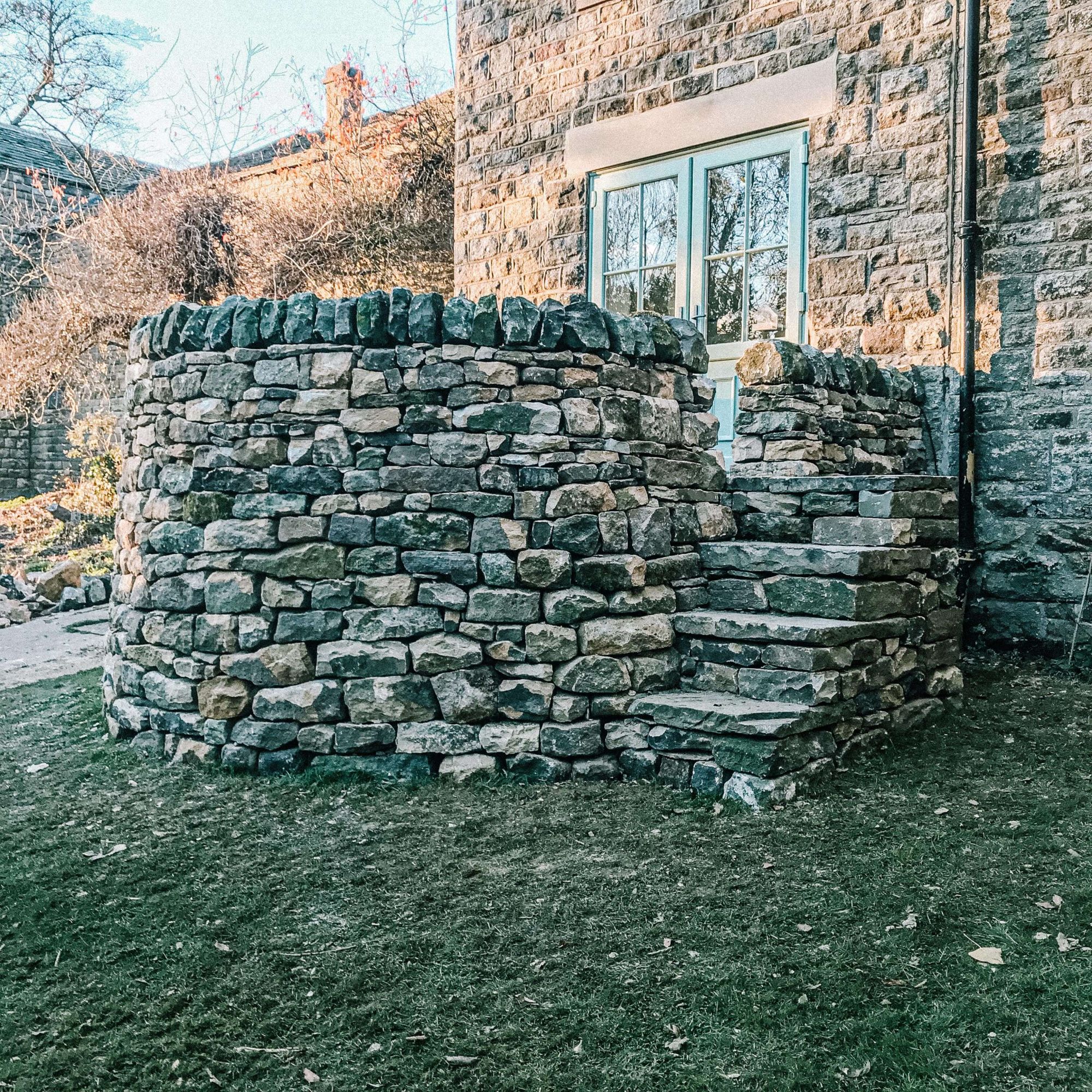 Dry stone walling - A circular dry stone wall with steps in Chesterfield